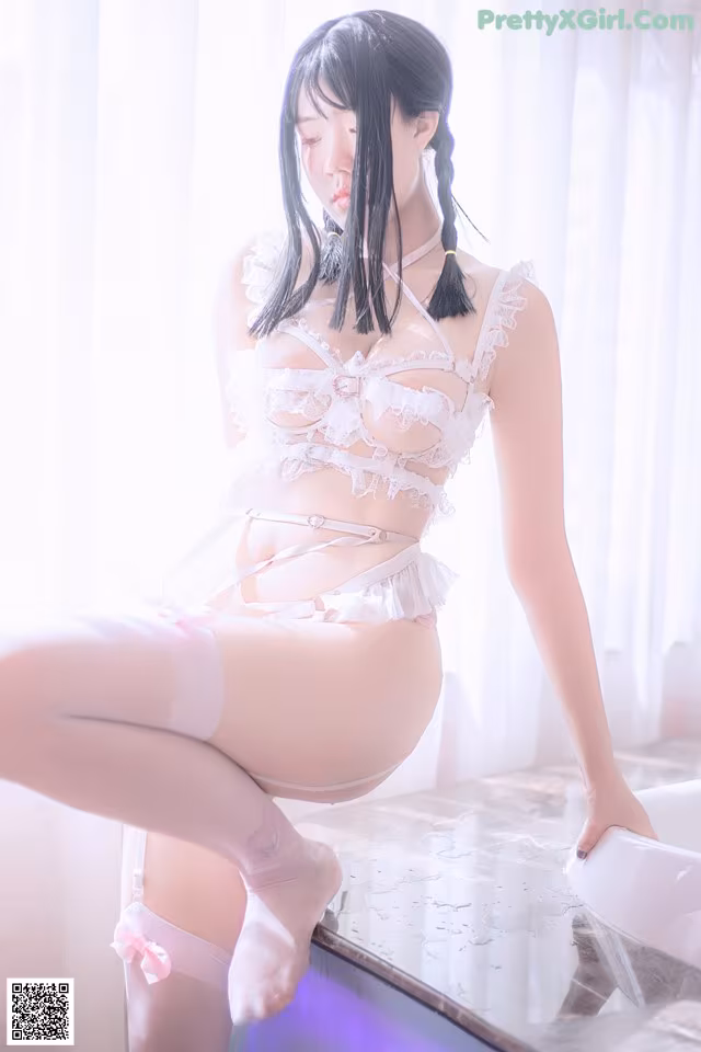 A woman in a white lingerie sitting on a bathtub.