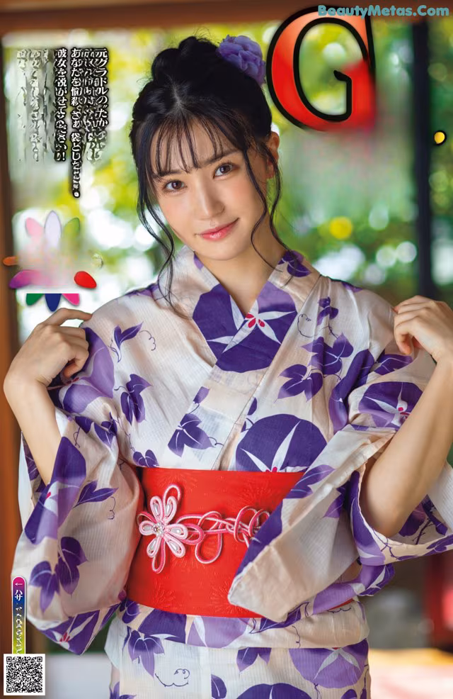 A woman in a purple and white kimono posing for a picture.