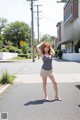 A woman standing in the middle of a street.